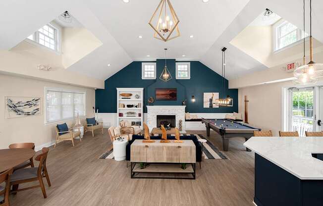 A large open living room with a fireplace and a pool table.