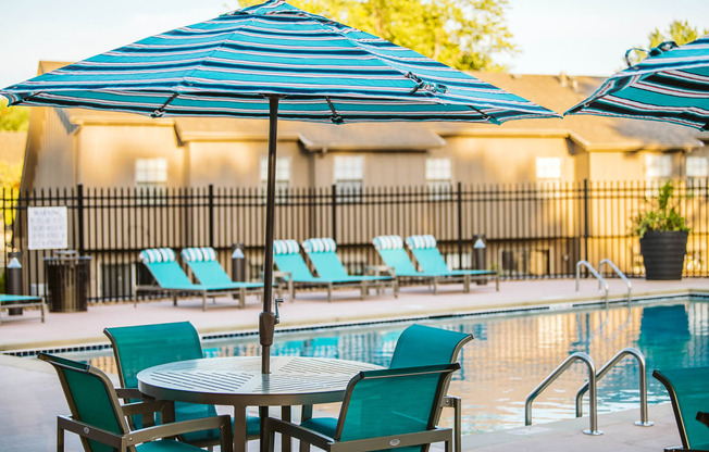 a pool with a table and chairs next to it