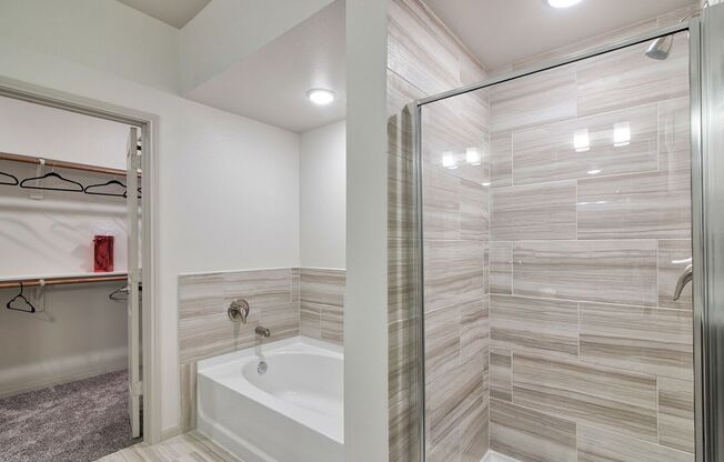 Walk-In Showers With Built-In Bench And Glass Enclosure at Seville at Clay Crossing, Texas