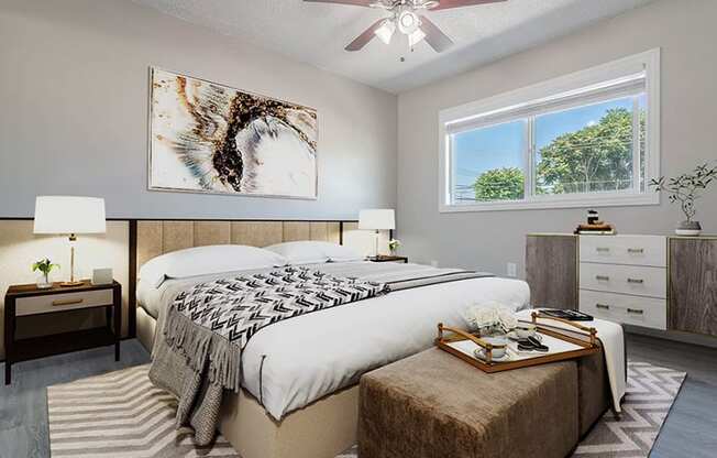 a bedroom with a bed and a ceiling fan