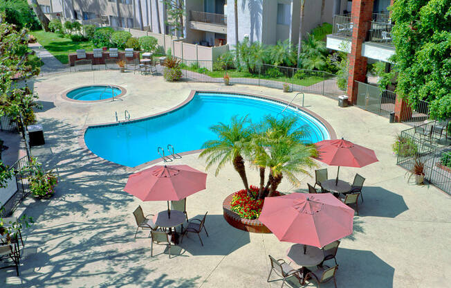 Downey Apartments for Rent - Park Regency Club Apartments Swimming Pool With Poolside, Shaded Patio Tables and Chairs