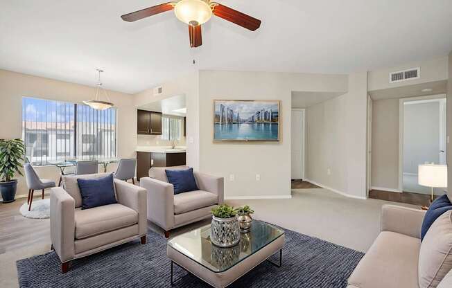 A living room with a ceiling fan, two couches, and a coffee table.