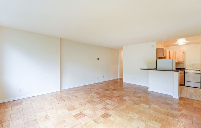 vacant living area with hard wood flooring and view of kitchen  at twin oaks apartments columbia heights washington dc