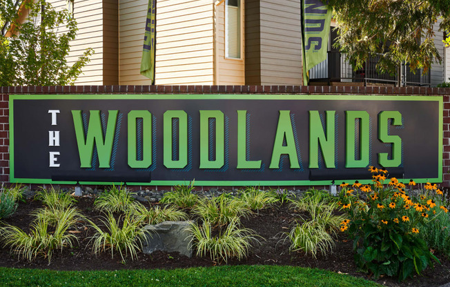 a sign in front of a house that says the woodlands