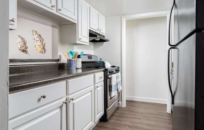 a kitchen with white cabinets and stainless steel appliances  at The Park at Chesterfield Apartment Homes, Florida, 33617