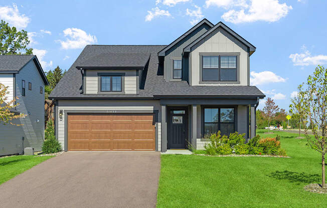 a house with a garage door in front of it