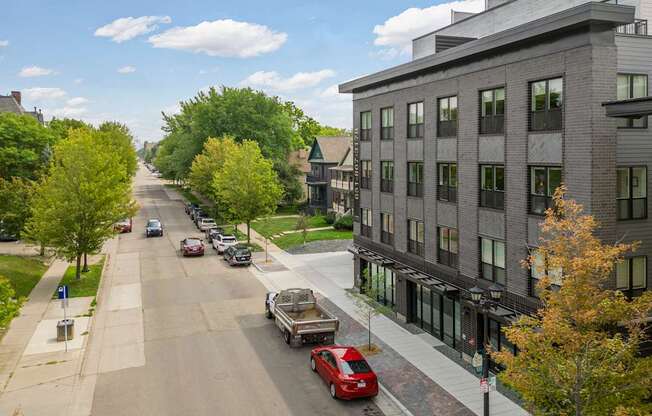 A street with cars and buildings on both sides.