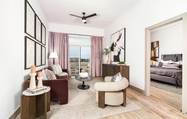 Bright living spaces feature wood-style flooring, elevated ceilings, and oversized windows that bring in abundant natural light.