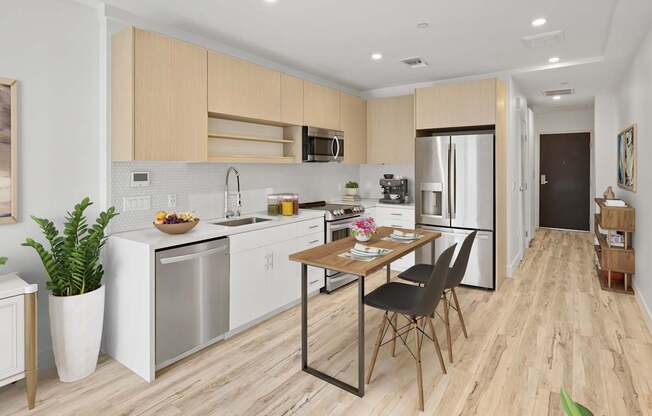 A modern kitchen with a dining table and chairs.