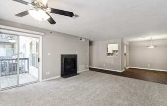 Unfurnished living room with a fireplace and a ceiling fan at Oakley Run apartments in Smyrna, GA