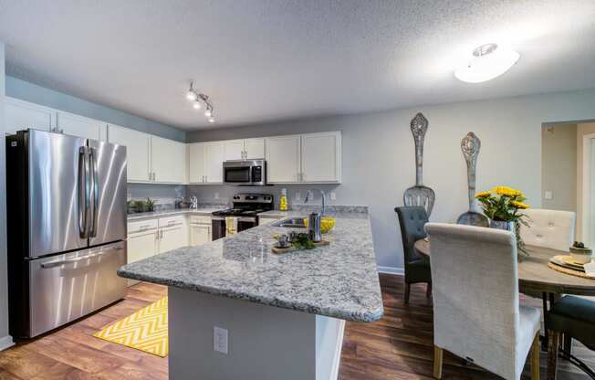 Kitchen with Island/Bar, Stainless Steel Appliance Package, Granite Countertops and round Dining Room Table with 4 chairs