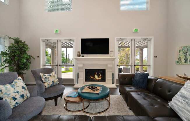 A living room with a fireplace and a flat screen TV.