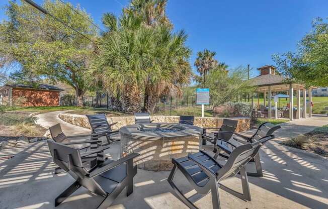 a group of chairs around a patio with a fire pit  at Sunset Ridge, San Antonio, TX