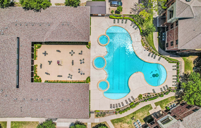 A large outdoor swimming pool with a slide.