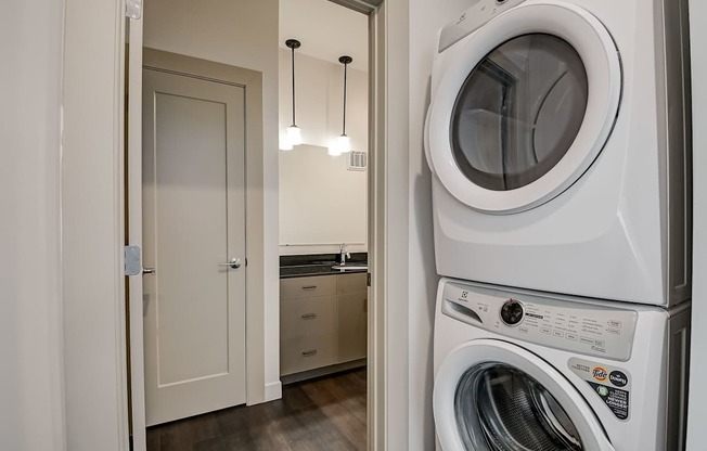 A white washing machine in a laundry room.