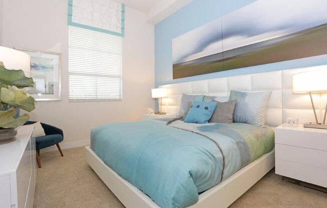 a blue and white bedroom with a bed