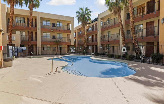 Enjoy a refreshing escape in this beautiful apartment community with a sparkling pool and lush palm trees.
