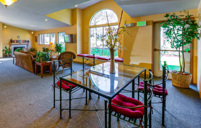 a living room with a glass table and chairs