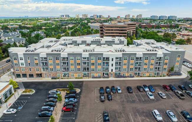 an aerial view of a large building with a parking lot in front of it