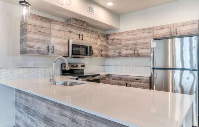 A modern kitchen with a wooden backsplash and stainless steel appliances.