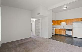 A kitchen with white appliances and wooden cabinets.