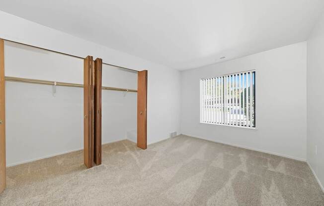 A room with a carpeted floor and a sliding door.