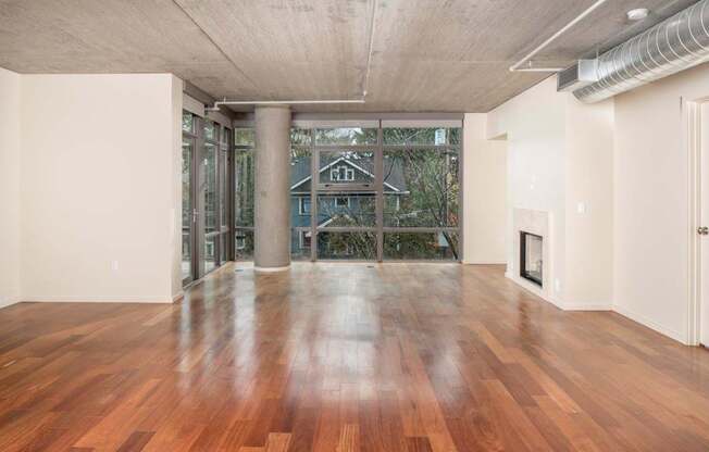 A room with wooden floors and a fireplace.
