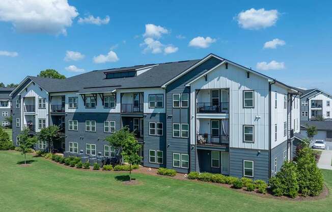 A large apartment complex with multiple buildings and green lawns.