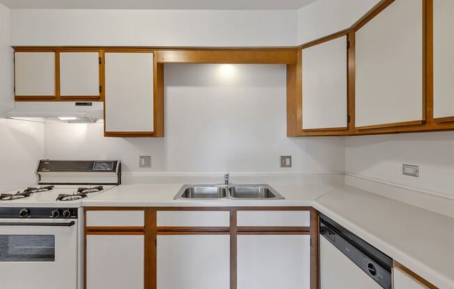 a kitchen with white cabinets and white countertops