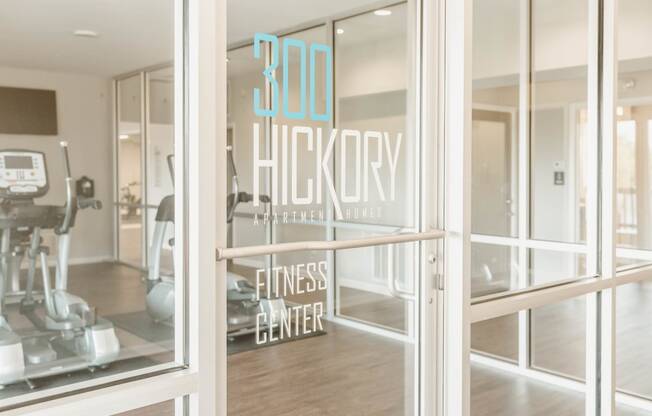 a gym with a sign in the window that reads 300 hickory fitness center