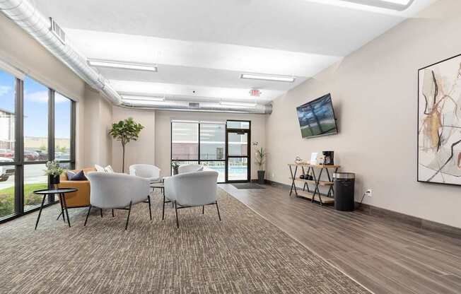 A room with white chairs and a brown carpet.