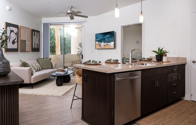 A modern kitchen with dark wood cabinets and stainless steel appliances.