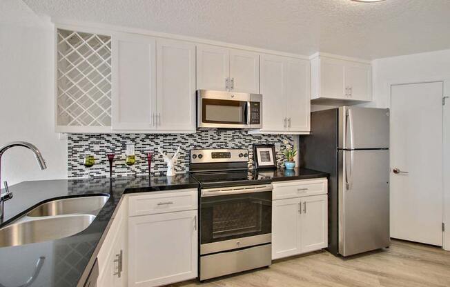 a kitchen with a stove top oven next to a refrigerator  at Masselin Park West, California, 90036