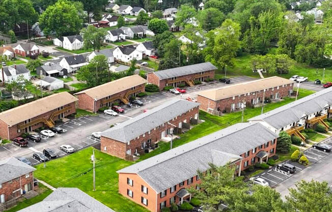 A large building complex with a parking lot in front.