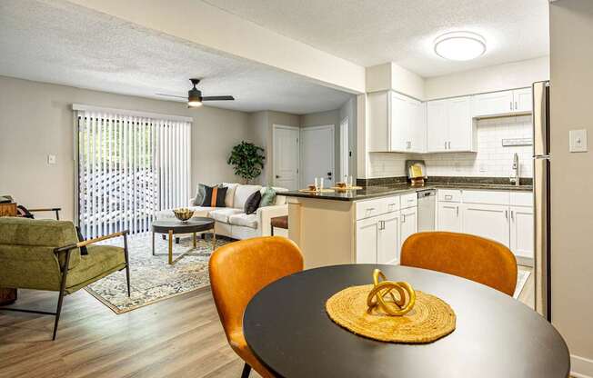 A dining room with a round table and chairs.
