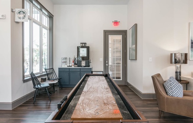 the living room has a shuffleboard table in the middle of it at Village at Westland Cove Apartments, Knoxville, TN, 37922