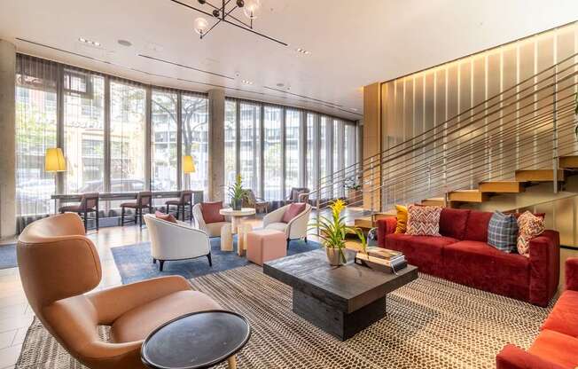 A living room with a red couch and a brown chair.