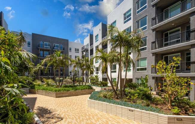 A modern apartment complex with a landscaped courtyard.