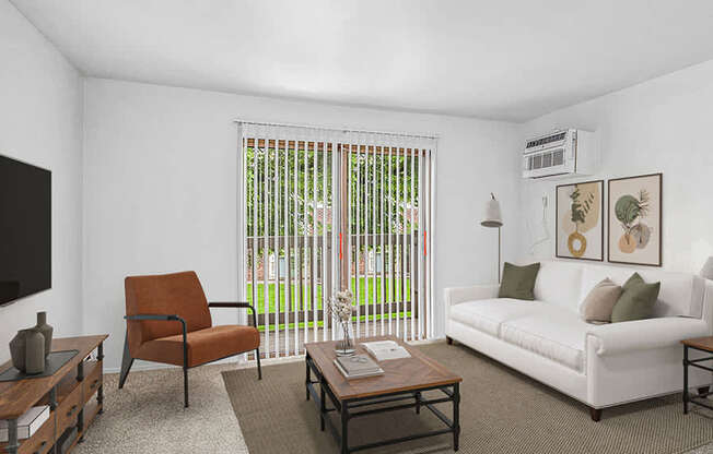 A living room with a white couch, a brown chair, and a coffee table at Wingate Apartments, Michigan