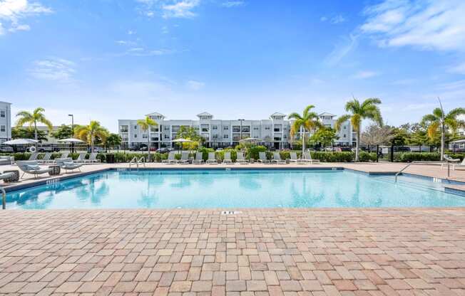 a resort-style swimming pool with artments in the background