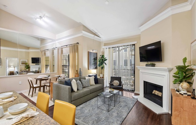 Living room with oversized windows for plentiful natural light and direct access to a private patio or balcony.