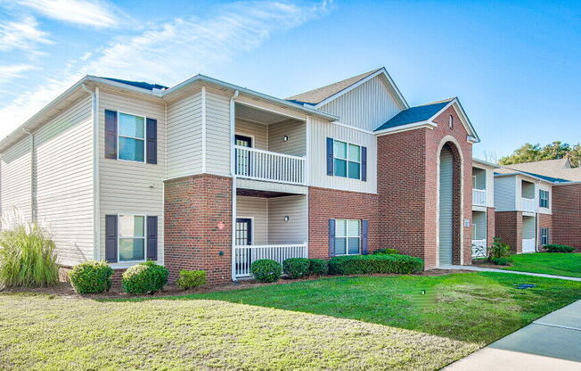 A row of townhouses with a clear blue sky above them.