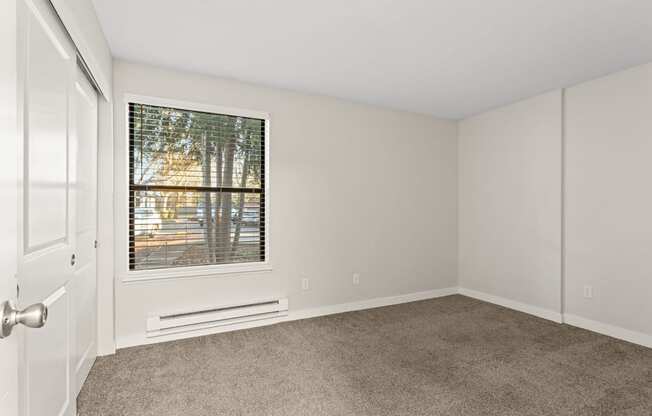 A room with a window and a door.