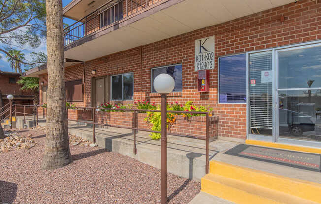 A building with a red brick exterior and a sign on the wall.