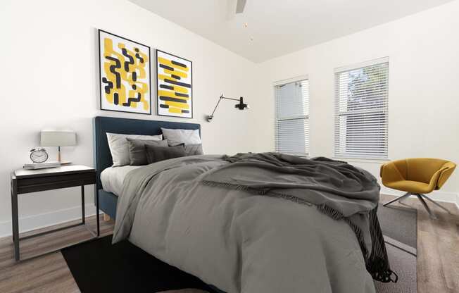 a bedroom with a bed and two paintings on the wall