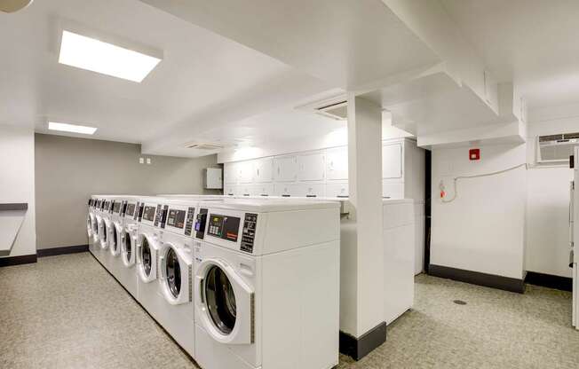 a washer and dryer closet in a laundry room with lots of washing machines at The Argonne Apartments, Washington, 20009