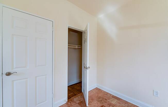 vacant bedroom with hardwood flooring and closet at 1401 sheridan apartments in washington dc