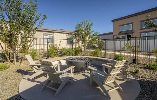 an outdoor patio with chairs and a fire pit at Grandstone at Sunrise, Peoria, AZ