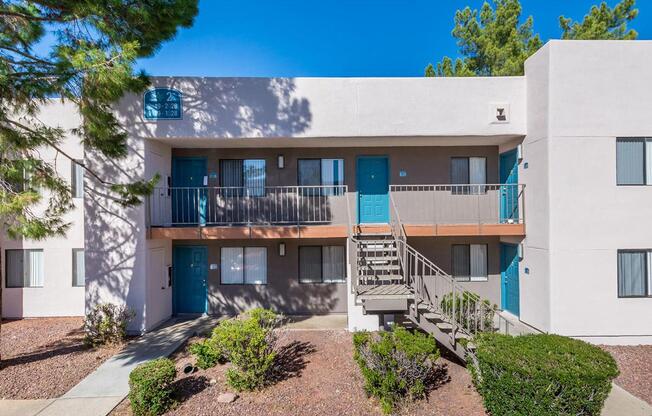 A modern apartment building with blue doors and windows.