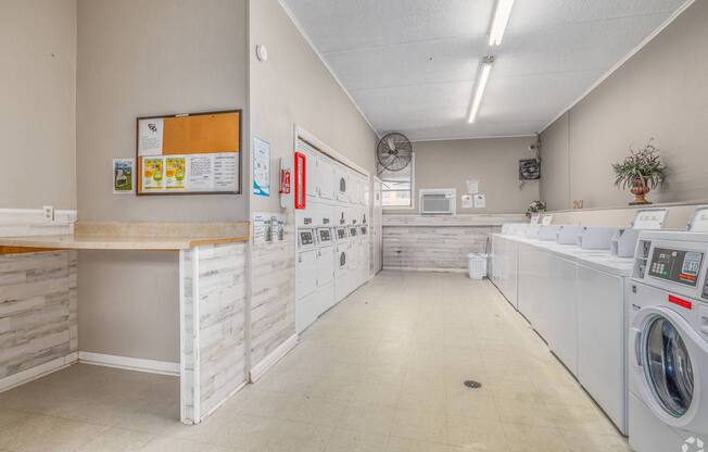 A laundry room with washers and dryers.
